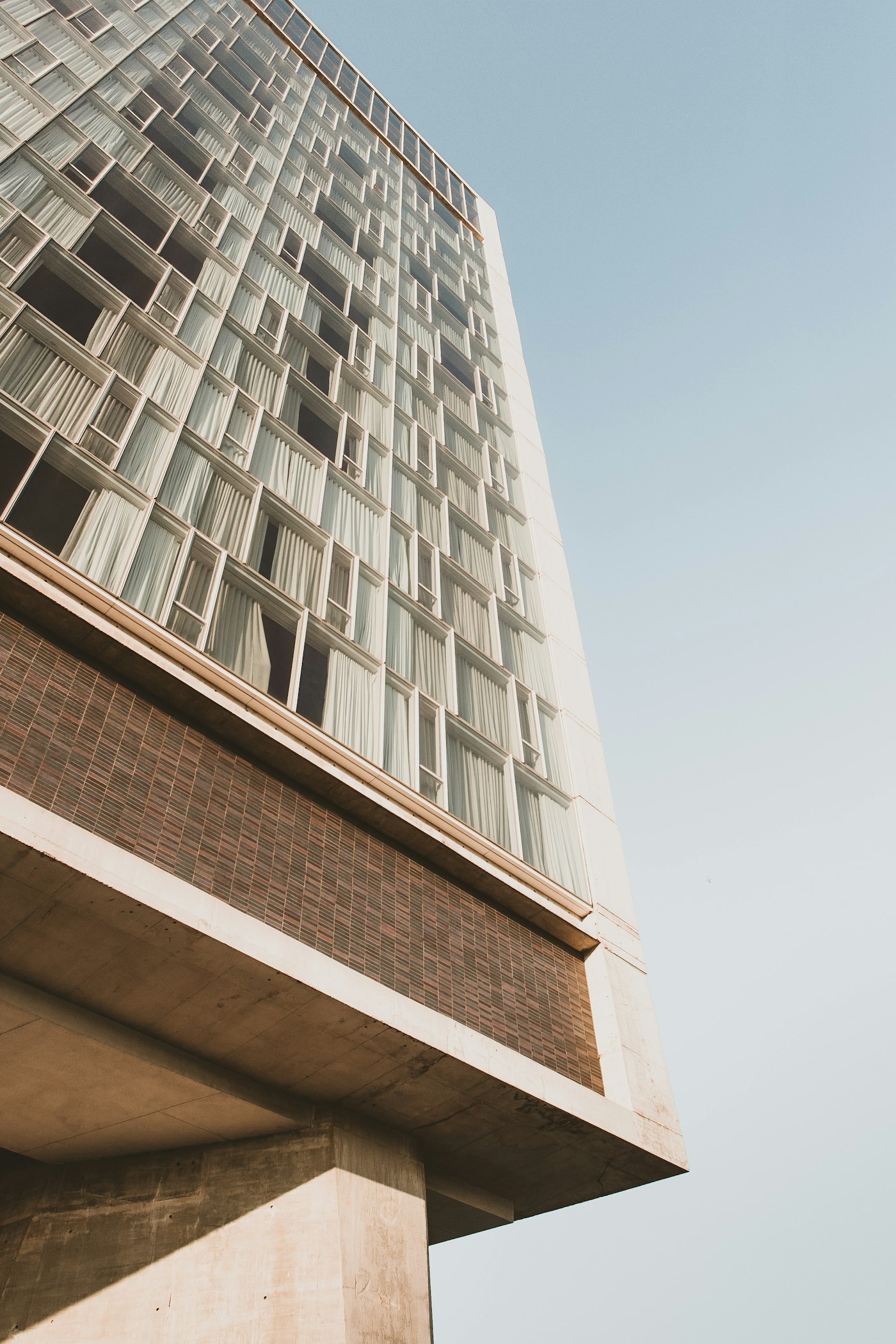 Facade of an upper-upscale hotel against a clear sky